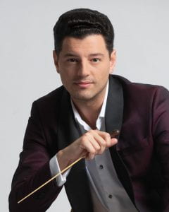 Portrait of Troy Quinn holding a conducting baton.